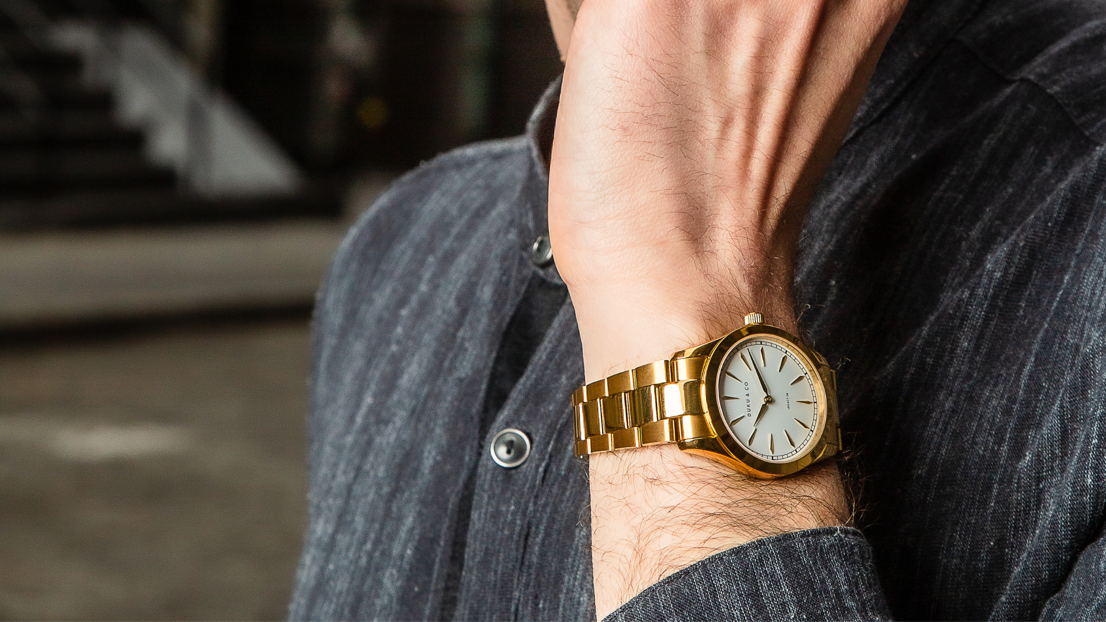 Man wearing gold watch from Duku & Co.