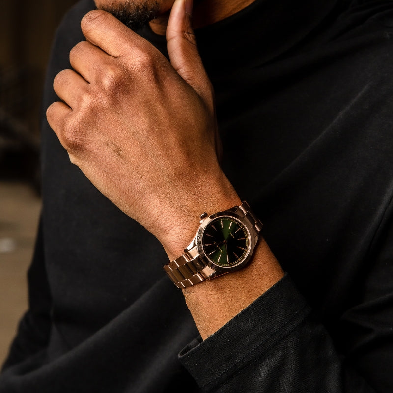 Man wearing a green and rose gold watch from Duku & Co.