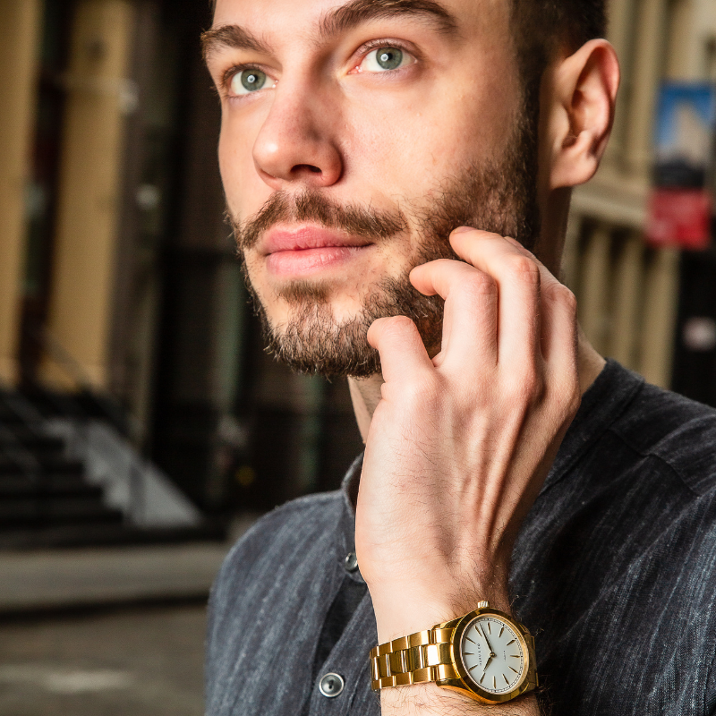Man wearing gold and white watch from Duku & Co.
