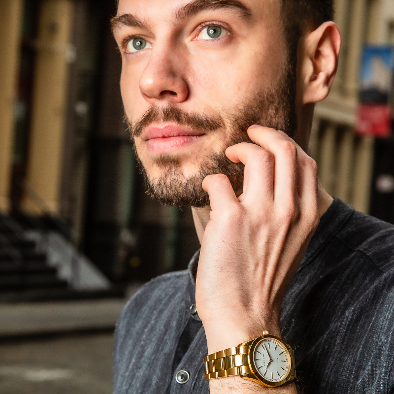 Man wearing gold and white watch from Duku & Co. 