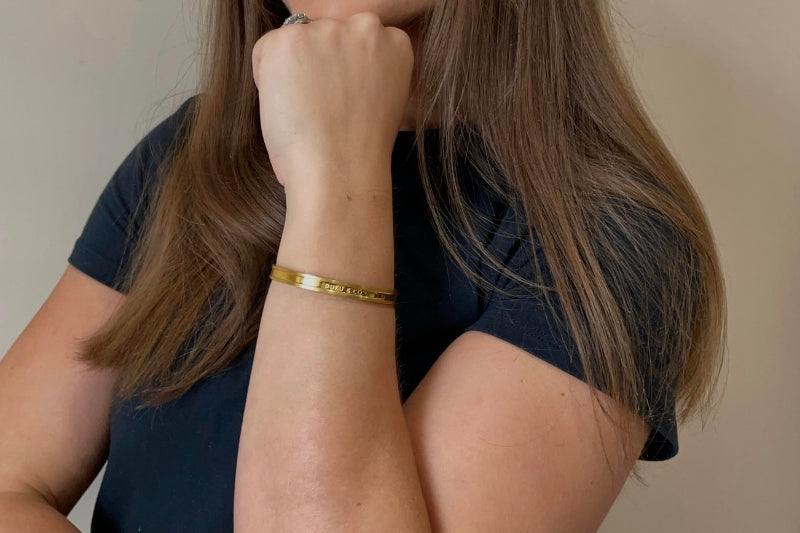 white woman wearing gold cuff bracelet from duku & co.