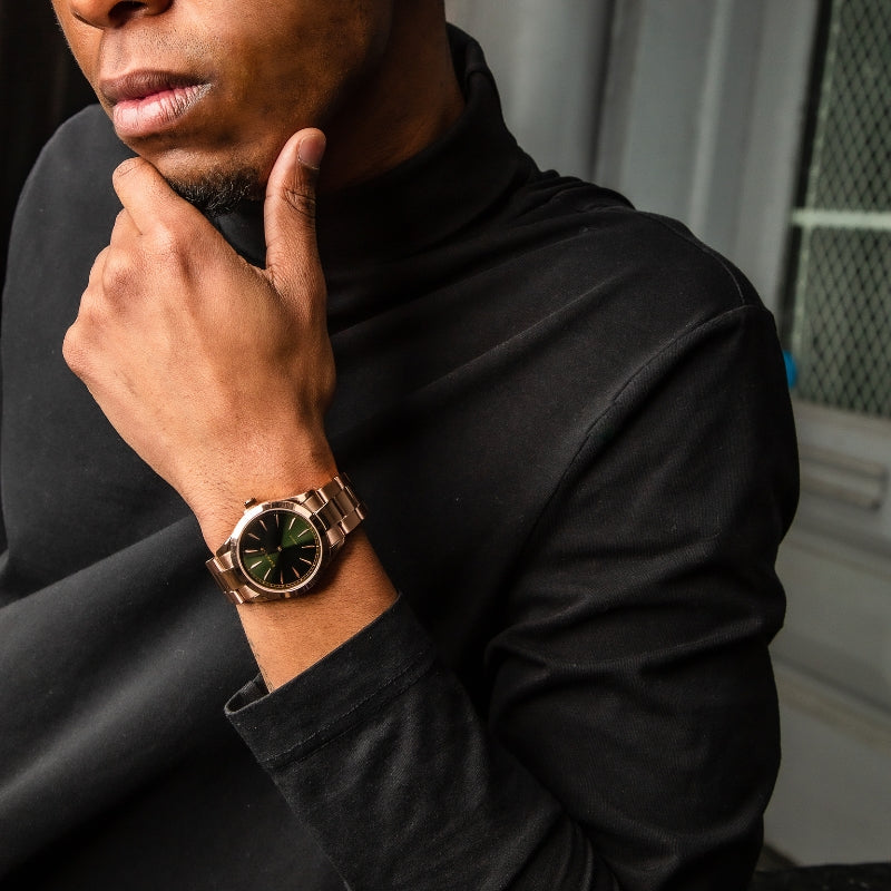 man wearing rose gold and green watch from duku & co.